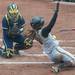 Michigan Sophomore Lauren Sweet misses the ball as Iowa's Johnnie Dowling slides into home during the first inning of their game at Alumni field Saturday, April 20.
Courtney Sacco I AnnArbor.com